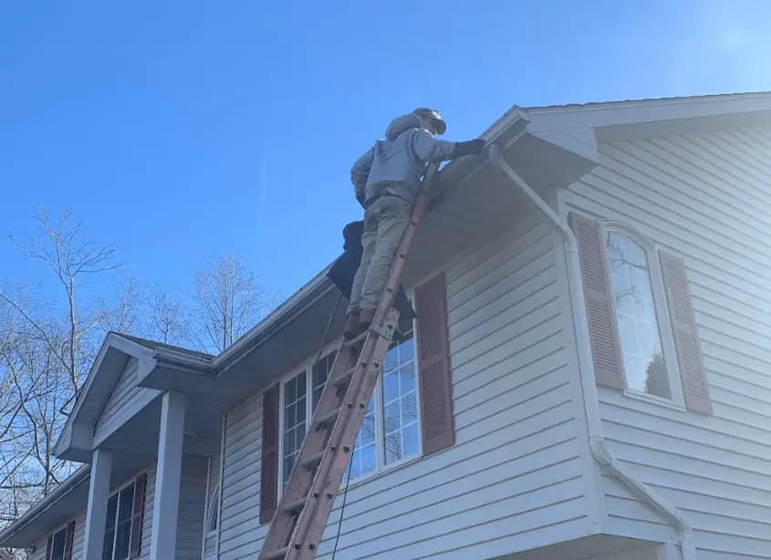 Gutter cleaning and maintenance being performed by North Olmsted Power Washing in North Olmsted